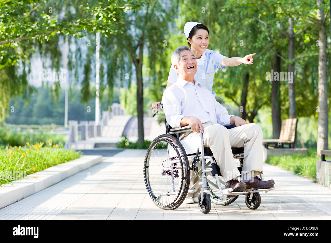 Nurse with wheelchair bound patient Stock Photo Alamy