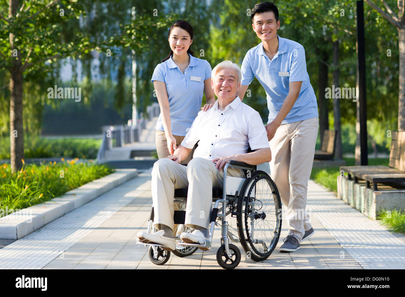 Wheelchair bound man with nursing assistants Stock Photo Alamy