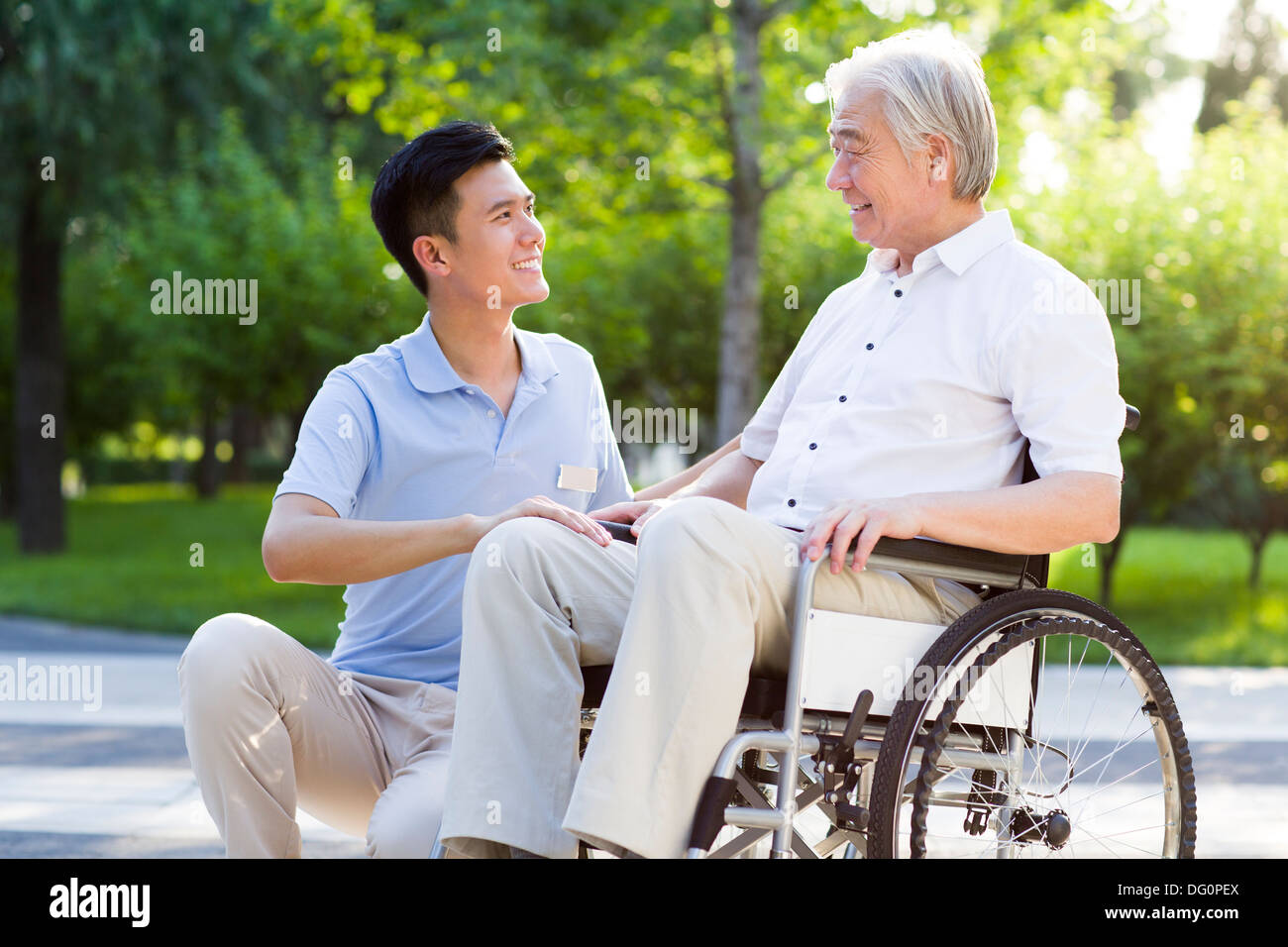 Wheelchair bound man with nursing assistant Stock Photo Alamy