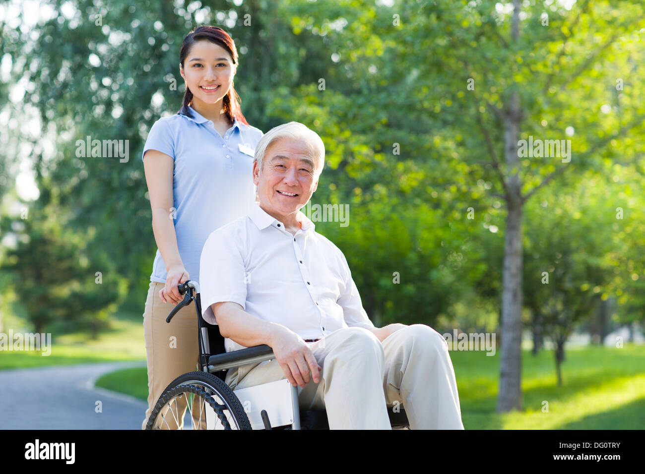 Wheelchair bound man with nursing assistant Stock Photo Alamy