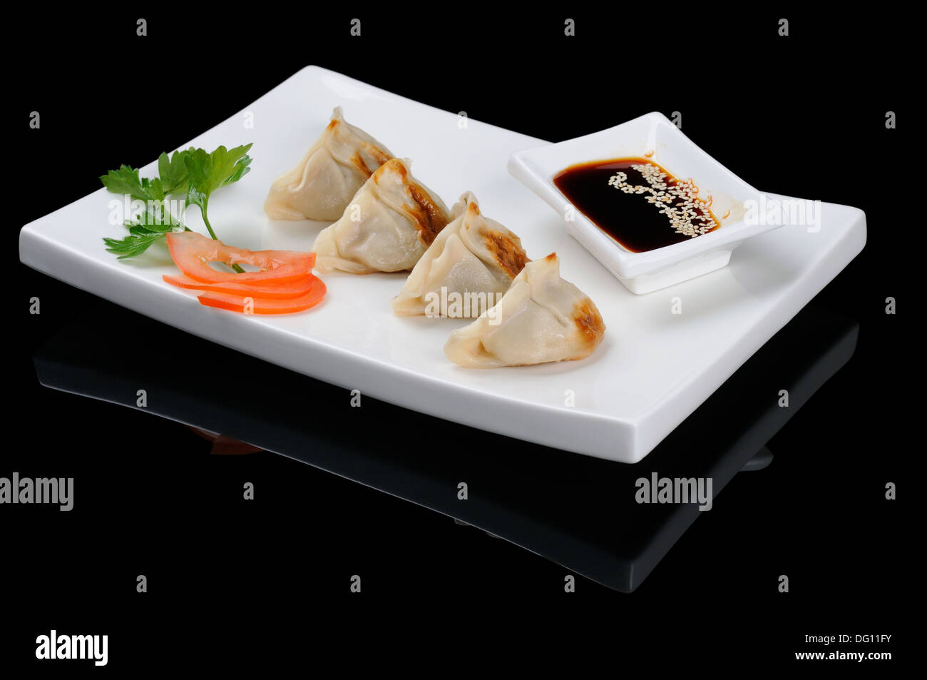 Japanese dumplings with soy sauce on black Stock Photo