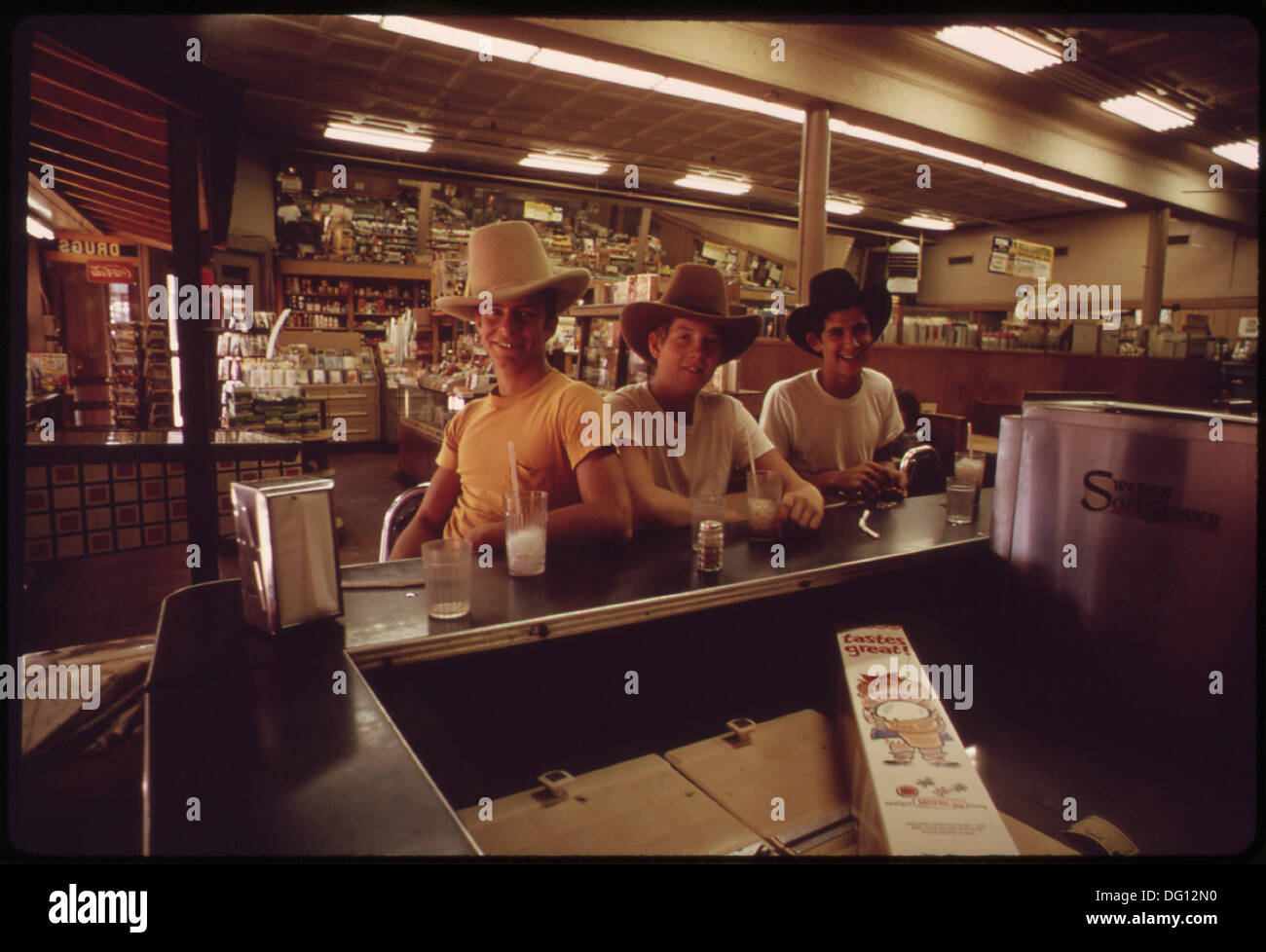 Teenagers in a drug store in the Stockyards area of Fort Worth, Texas, reflecting a moment of daily life in the mid-20th century in a vibrant commercial district. Stock Photo