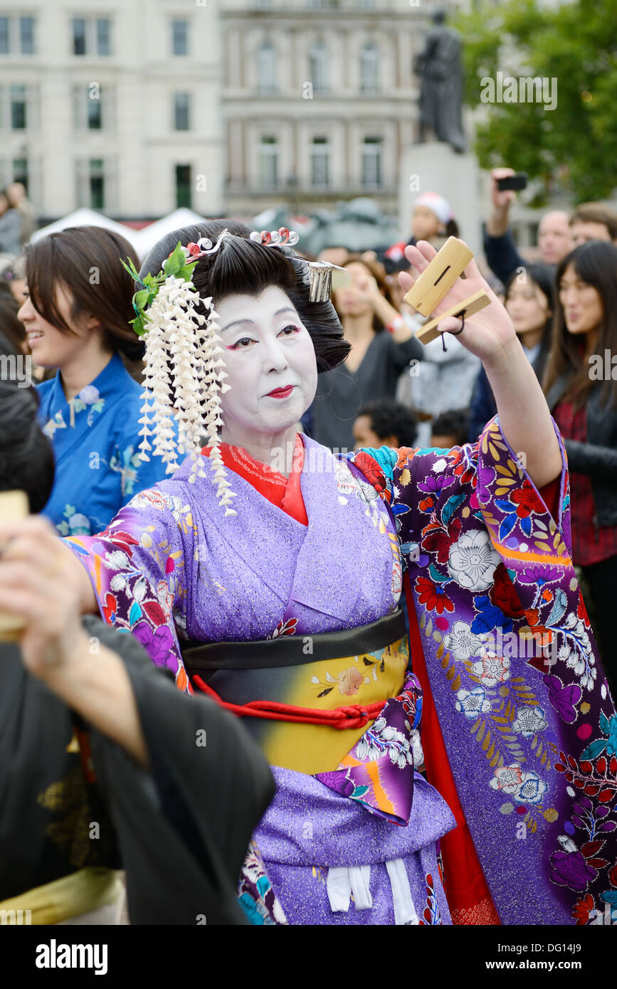 Japanese geisha dancing at matsuri festival wearing traditional costume of kimono in London England. Oct 5, 2013 Stock Photo