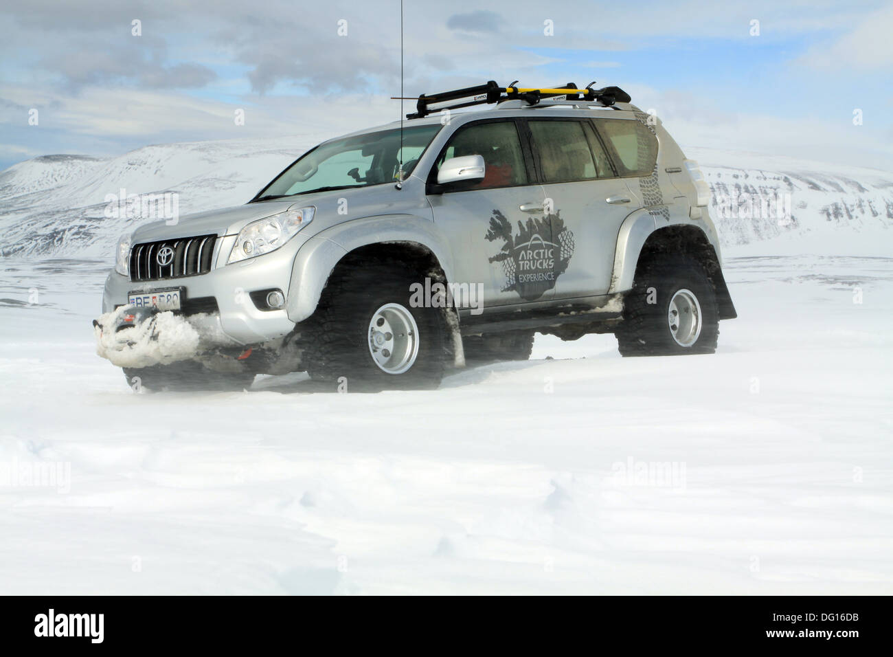 Arctic trucks heavily modified Toyota Landcruiser driving on snow in Iceland Stock Photo