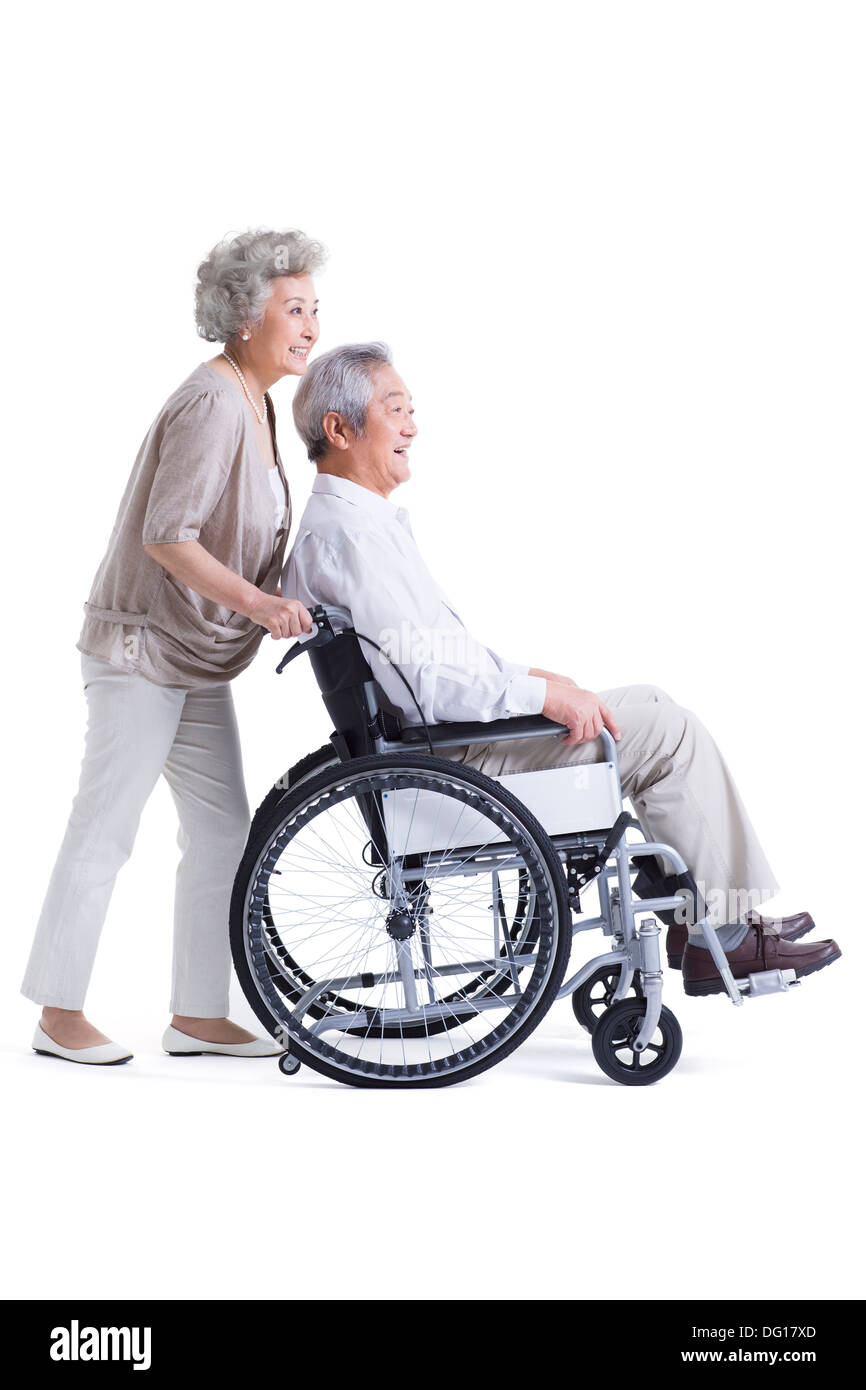Senior woman pushing wheelchair bound husband Stock Photo Alamy