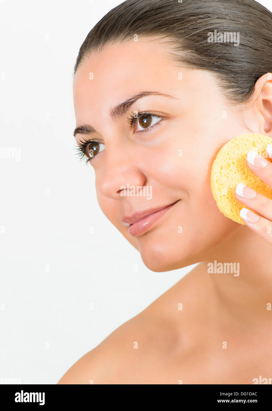 Young woman cleaning skin with cotton pad Stock Photo