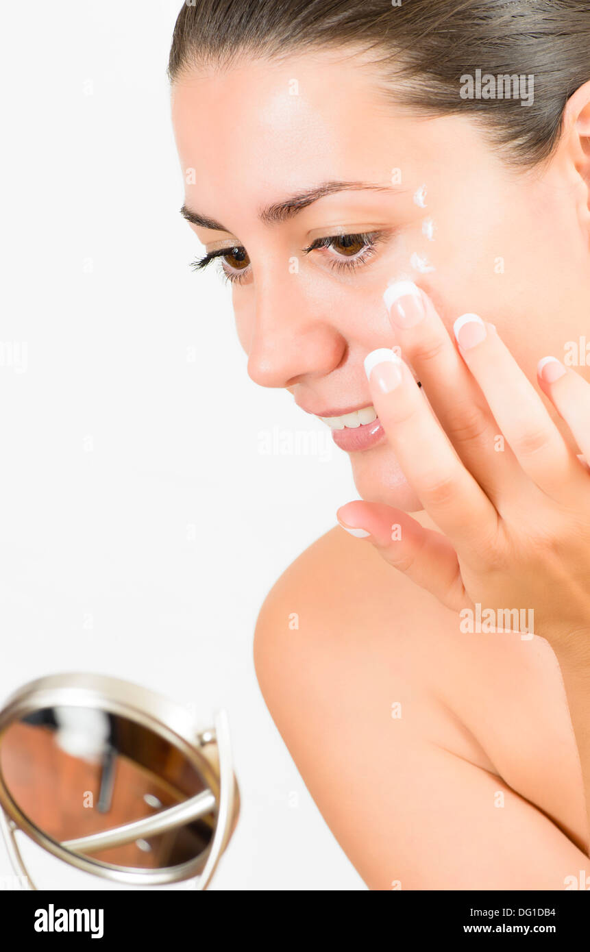 Close-up portrait of a young woman with perfect skin looking in the mirror Stock Photo