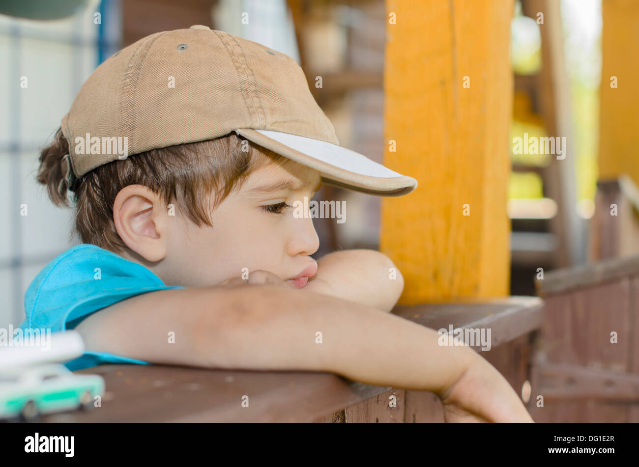 A wistful child on his porch Stock Photo