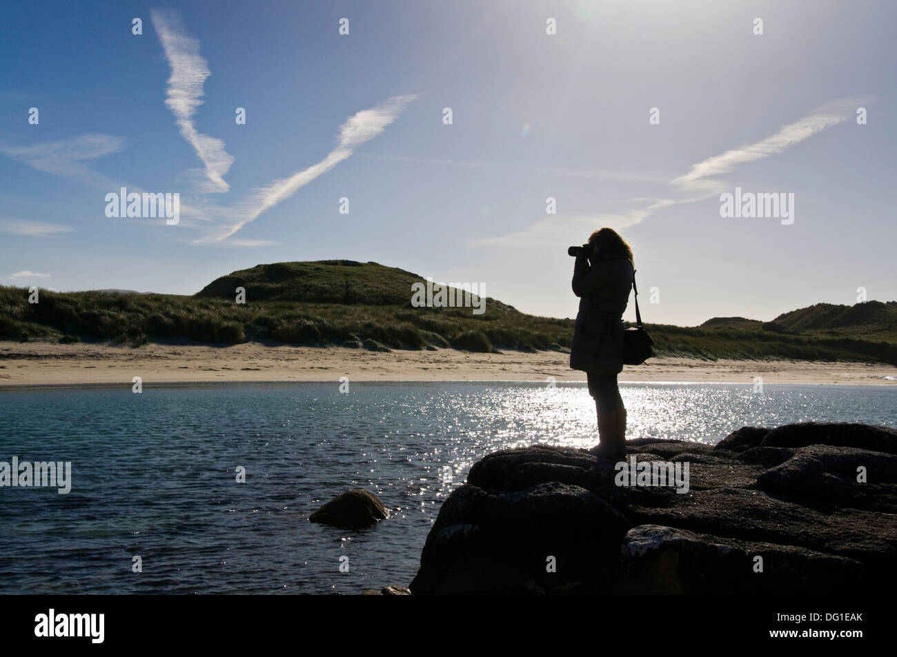 Woman takes digital photographs at Carrickfinn Kincasslagh County Donegal Ireland Stock Photo