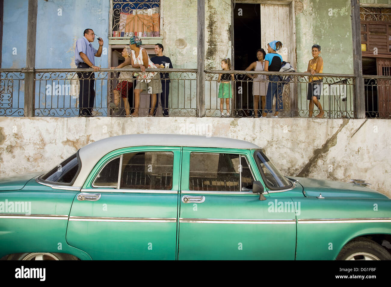 House and family in the town centre. Old car. Santiago de Cuba, Cuba