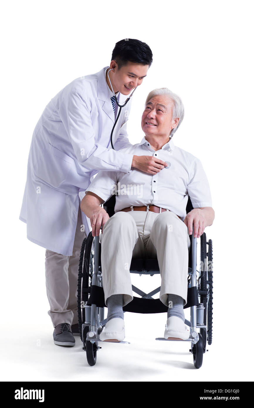 Doctor listening to wheelchair bound patient's heart Stock Photo Alamy