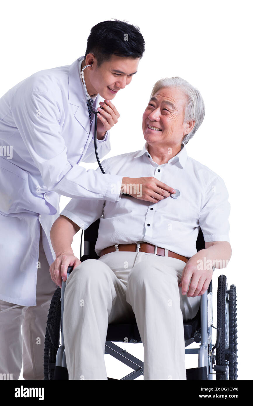 Doctor listening to wheelchair bound patient's heart Stock Photo Alamy
