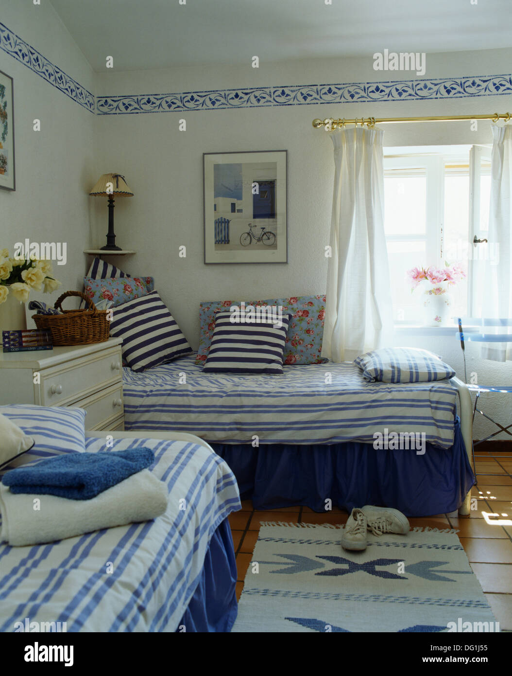 Blue White Striped Cushions And Duvet On Twin Beds In White