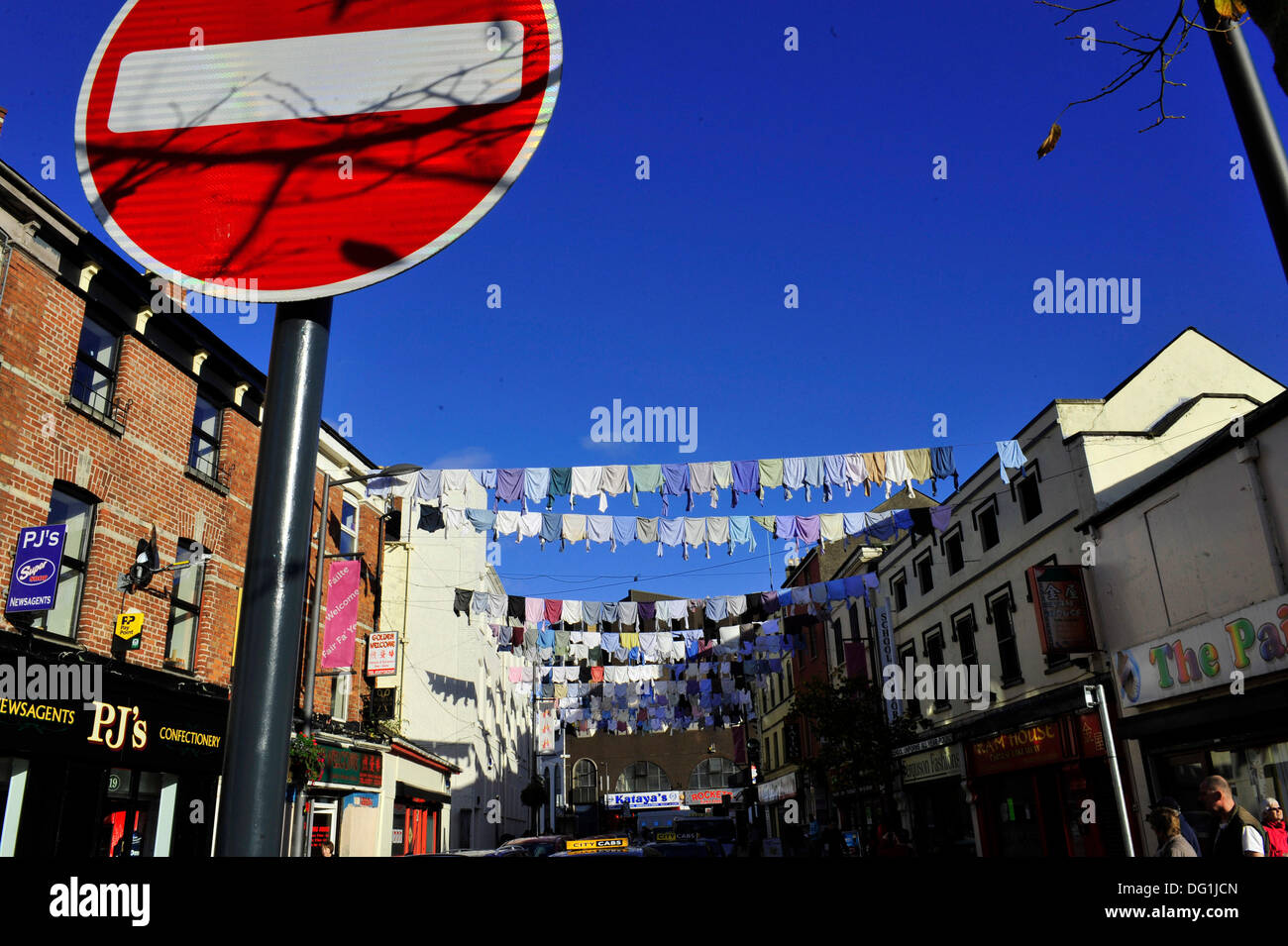 Derry, Londonderry, Northern Ireland, UK. 11th Oct, 2013. Belfast artist Rita Duffy celebrates Londonderry's shirt manufacturing history with a display of over 300 shirts hanging across William Street. The eye-catching art installation is an aspect of the artist's Shirt Factory project and part of the UK City of Culture celebrations. .  Credit: George Sweeney / Alamy Live News Stock Photo