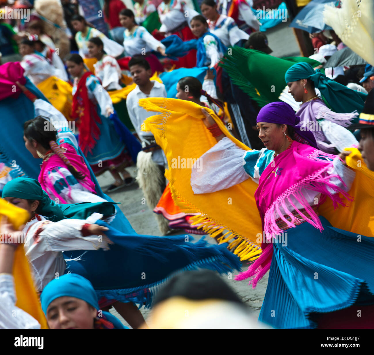 People in traditional Ecuadorean dresses dance as part of a parade through the streets celebrates its Spanish Foundation Stock Photo