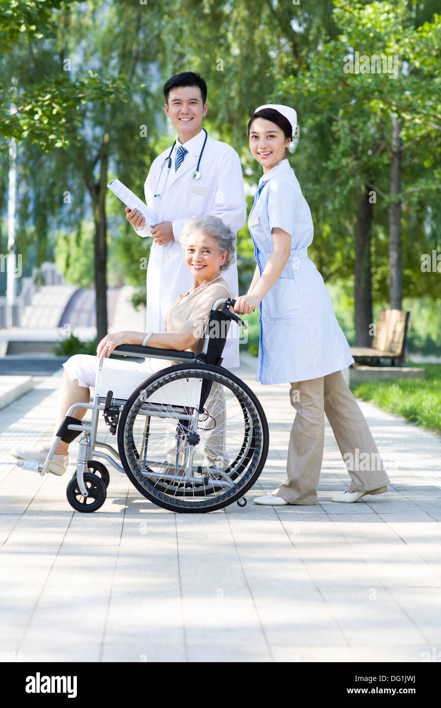 Doctor, nurse and wheelchair bound patient Stock Photo Alamy