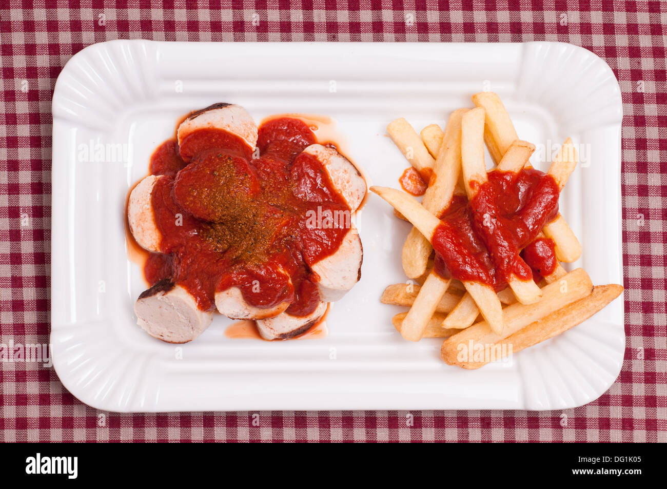 Sausage in curry sauce with chips Stock Photo Alamy