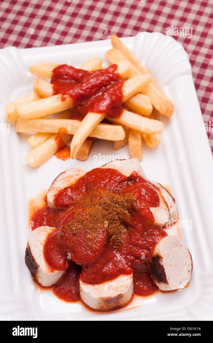 Curry sausage with hot sauce and chips Stock Photo Alamy