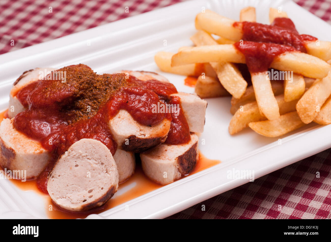 Curried sausage with spicy sauce and chips Stock Photo Alamy