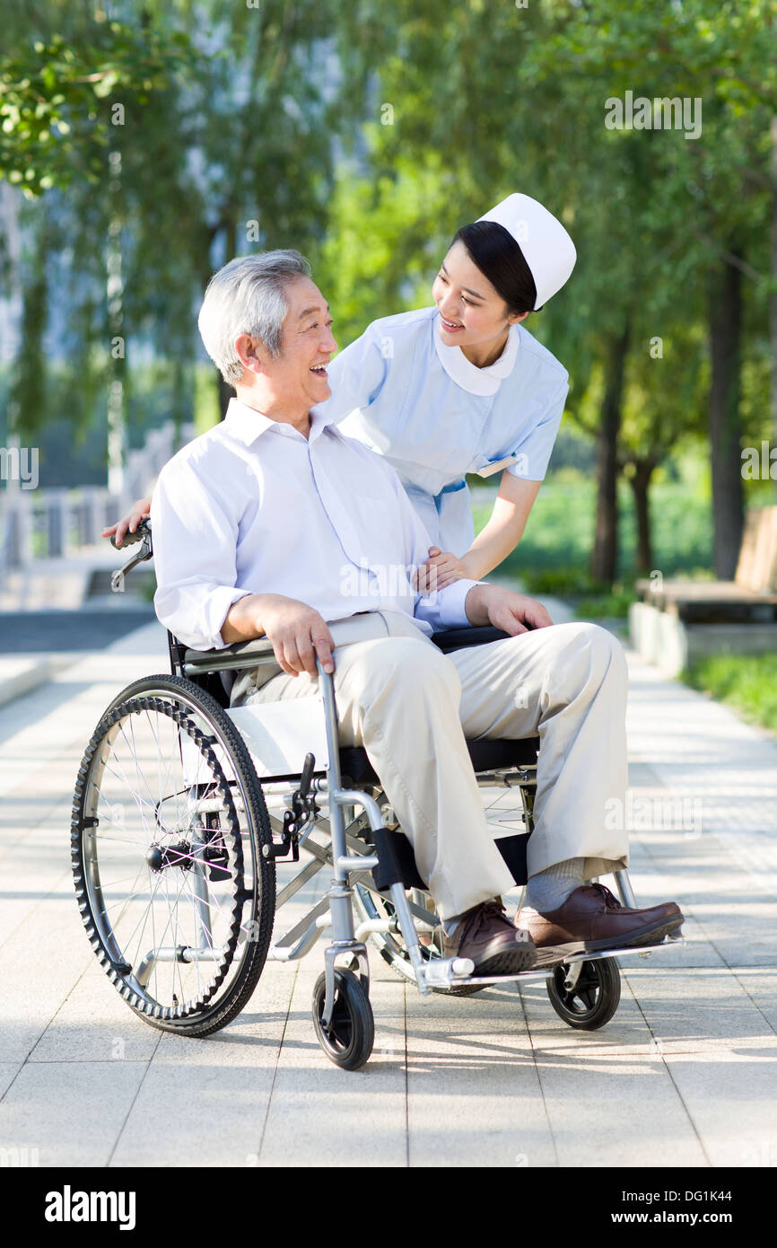 Nurse with wheelchair bound patient Stock Photo