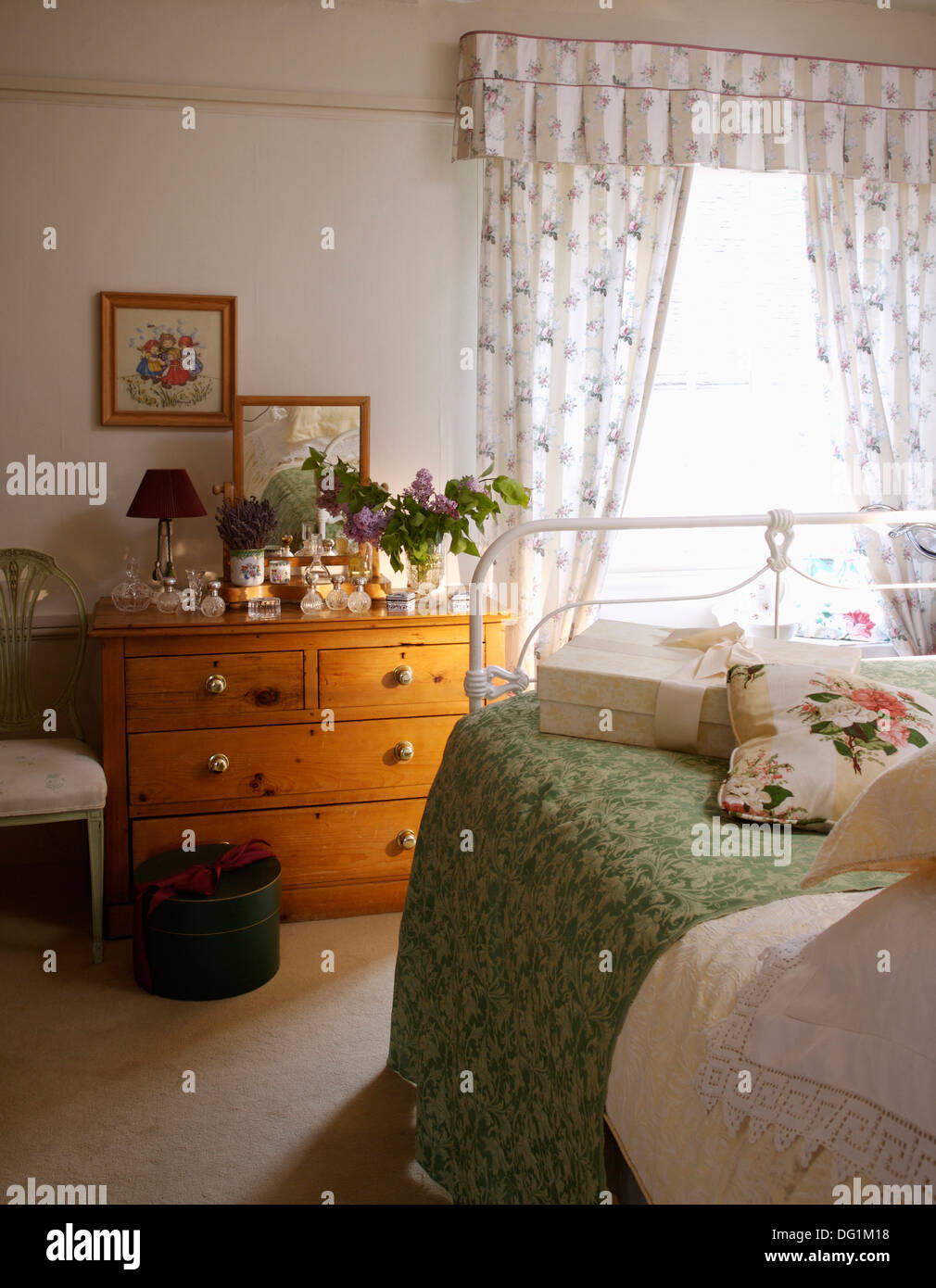 Pictures Above Pine Chest Of Drawers In Country Bedroom With