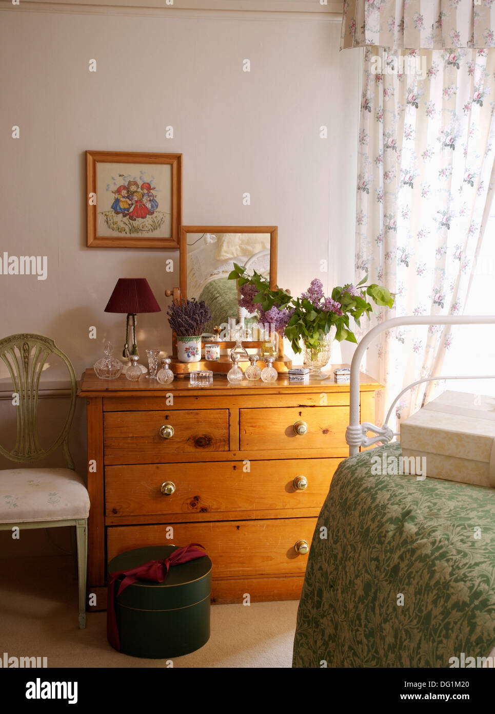 Pictures Above Pine Chest Of Drawers In Country Bedroom With