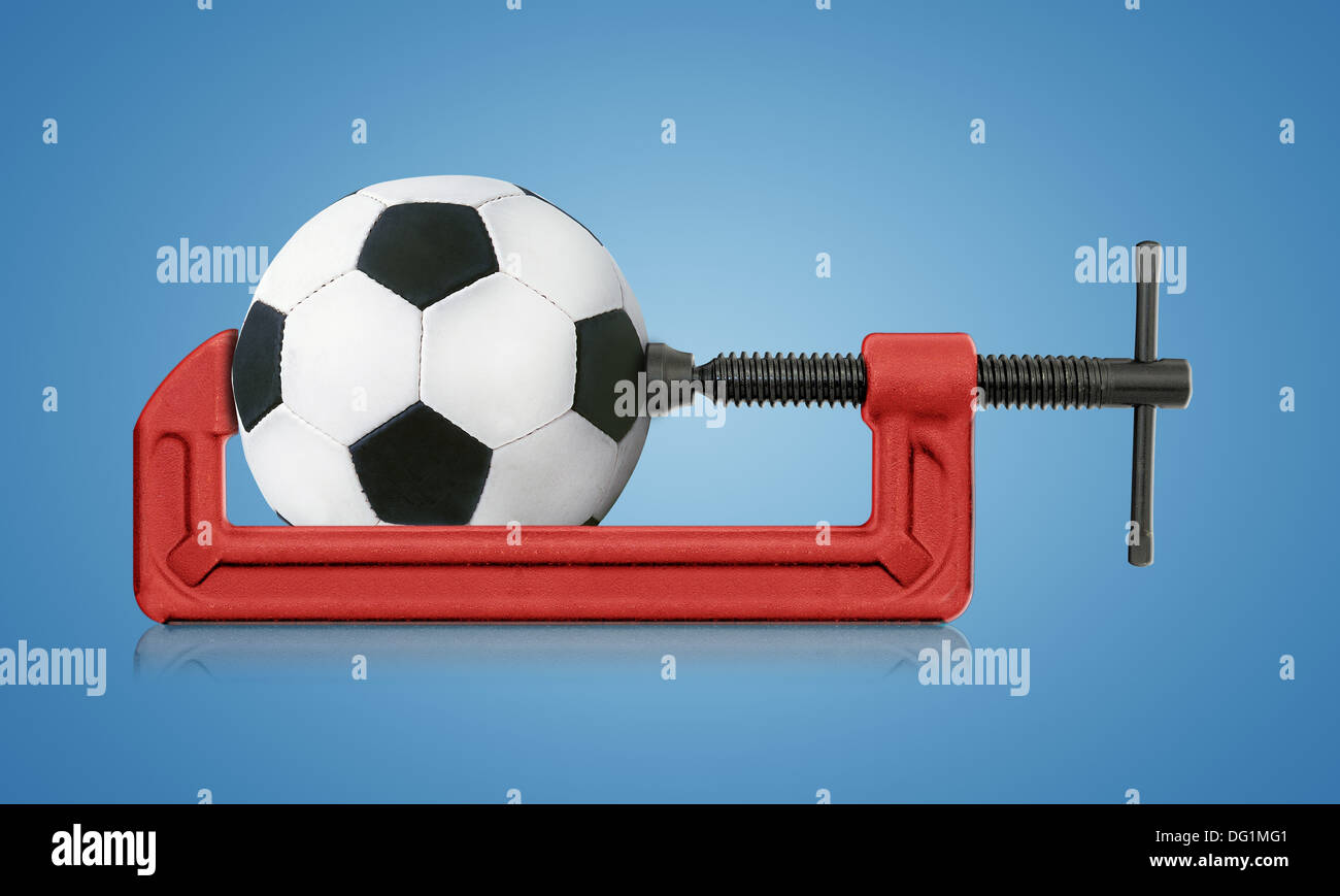 horizontal hand vise cclamp and football, sport conceptual image Stock