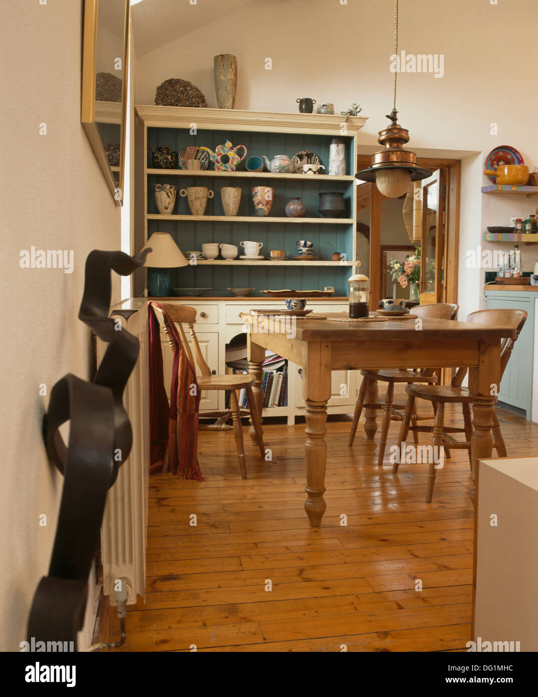 Wooden flooring in country kitchen with traditional pine wood table and