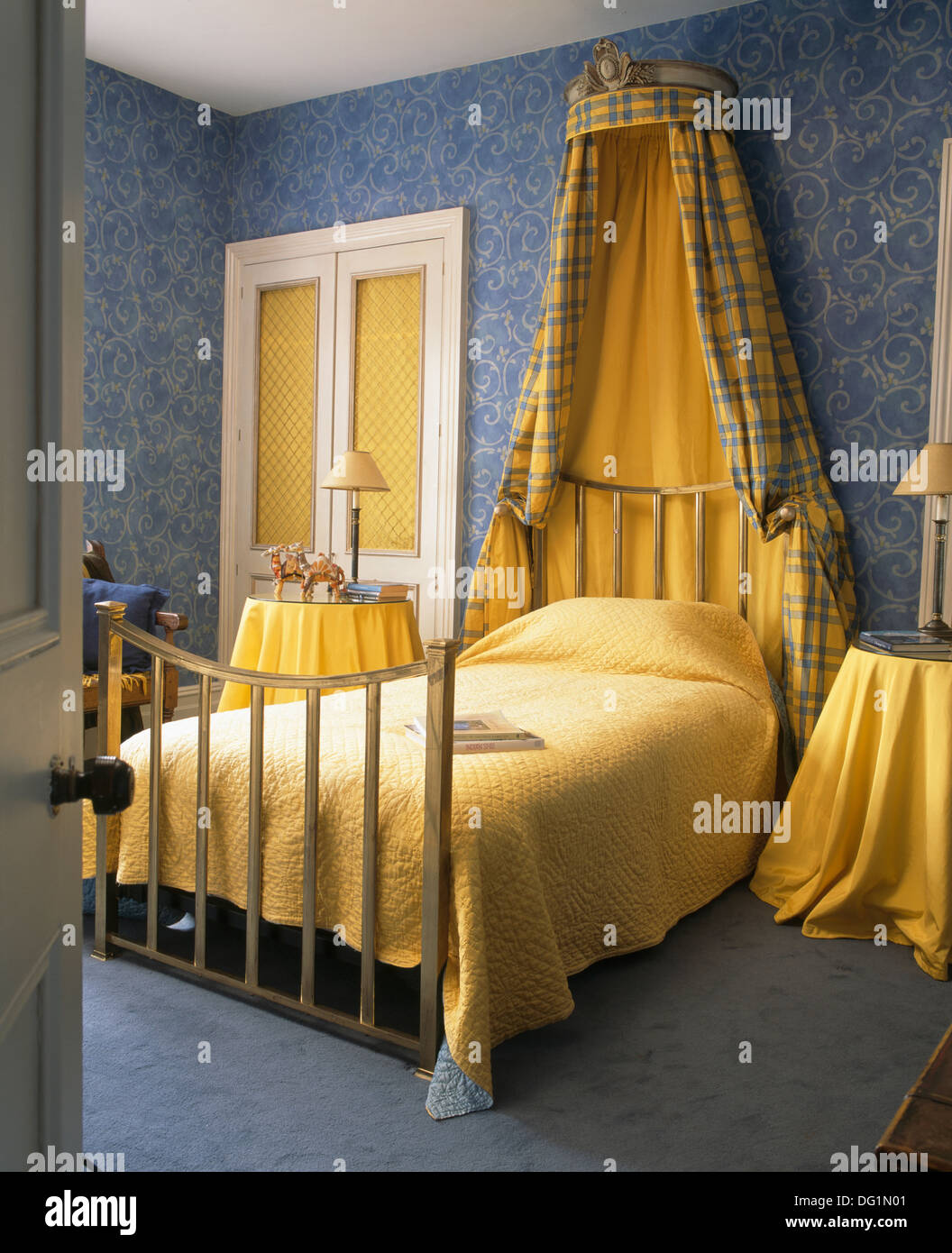 Coronet With Yellow Drapes Above Brass Bed With Yellow Quilt In