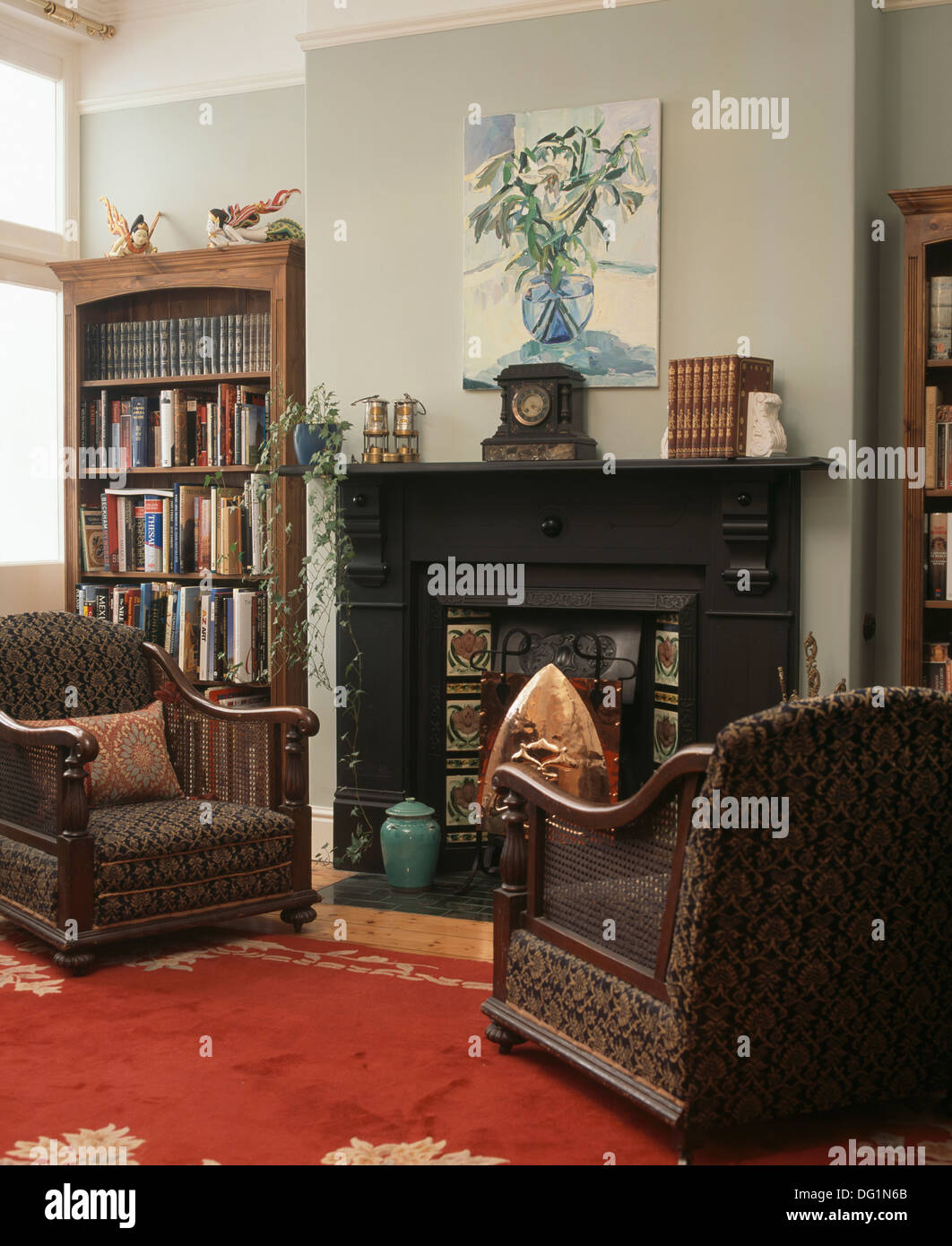 Antique Bergere armchairs in front of fireplace in gray living room ...