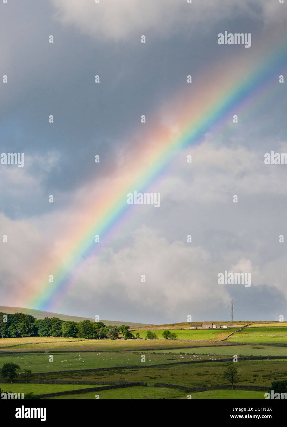 Rainbow over Northumbrian dale. Stock Photo