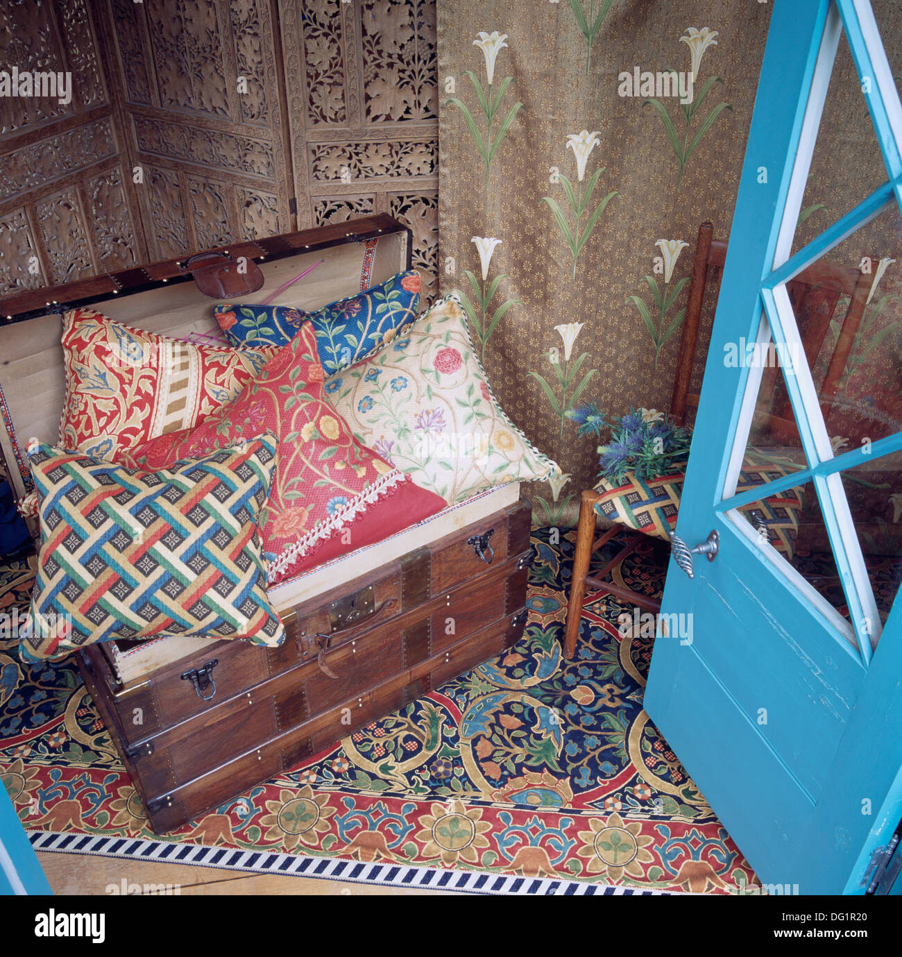 Colorful Patterned Cushions On Old Wooden Chest On Balcony With