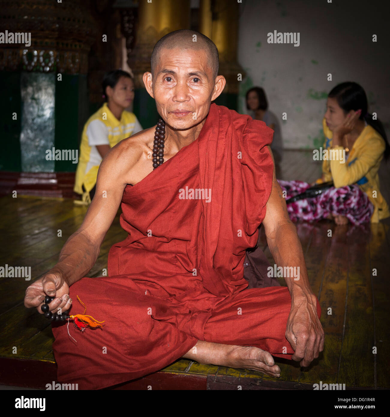 Elderly Buddhist monk at Shwedagon Pagoda, Yangon, (Rangoon), Myanmar, (Burma) Stock Photo