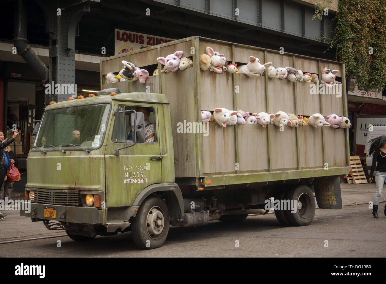 New York City, NY, USA. 11th Oct, 2013. Banksy enthusiasts flock to the trendy Meatpacking District in New York on Friday, October 11, 2013 to see the eleventh installment of Banksy's art, 'The Sirens of the Lambs'. This particular sculptural piece consists of a slaughterhouse truck filled with bleating plush animals, controlled by puppeteers, which were driven around by a driver, who remained in character. Credit:  Frances Roberts/Alamy Live News Stock Photo