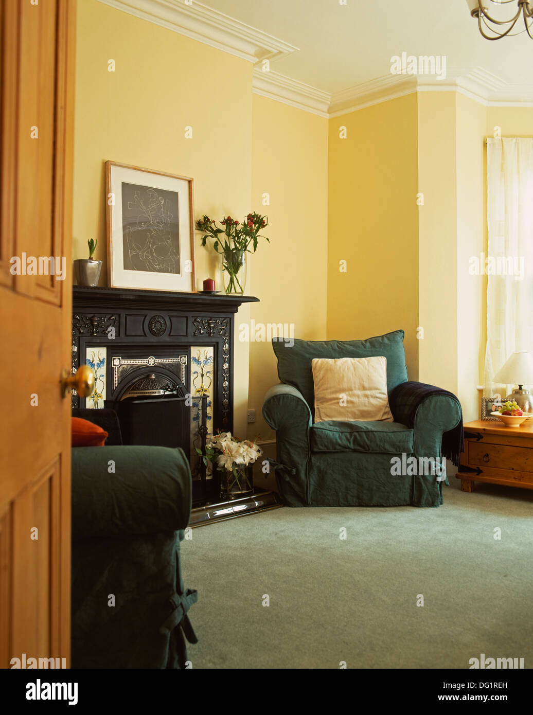 Dark Green Loose Covers On Armchairs In Traditional Living Room With Victorian Fireplace And Gray Carpet Stock Photo Alamy