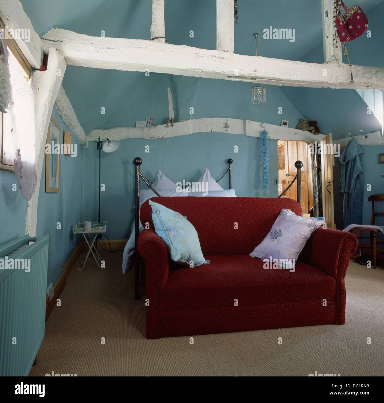 Red Velvet Sofa In Pastel Blue Attic Bedroom With White