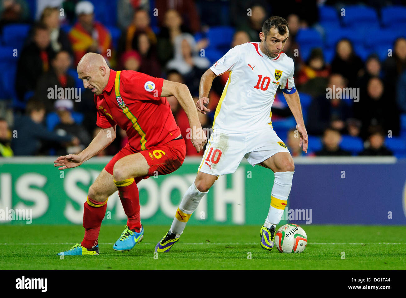 Cardiff, Wales. 11th Oct, 2013. Goran Pandev of Macedonia beats James Collins of Wales (West Ham United) during the second half of the FIFA 2014 World Cup (European Region) Group A Qualifier between Wales and Macedonia at Cardiff City Stadium. Credit:  Action Plus Sports/Alamy Live News Stock Photo