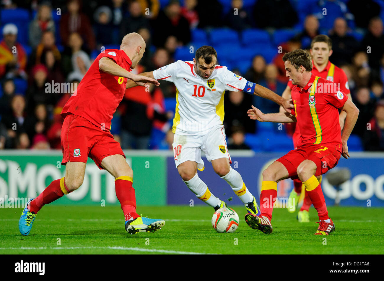 Cardiff, Wales. 11th Oct, 2013. Goran Pandev of Macedonia beats Andy King (Leicester City) and James Collins of Wales (West Ham United) during the second half of the FIFA 2014 World Cup (European Region) Group A Qualifier between Wales and Macedonia at Cardiff City Stadium. Credit:  Action Plus Sports/Alamy Live News Stock Photo