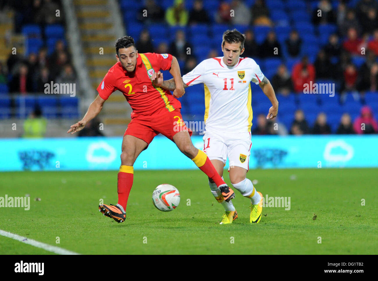 Cardiff, Wales, UK. 11th Oct, 2013. FIFA 2014 World Cup Qualifying Match - Wales v Macedonia at the Cardiff City Stadium : Neil Taylor of Wales is tackled by Aleksander Trajkovski of Macedonia. Credit:  Phil Rees/Alamy Live News Stock Photo