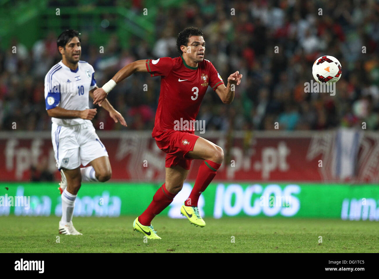Lisbon, Portugal. 11th Oct, 2013. Elyaniv Barda, Israel forward (L) and Pepe, Portugal defender (R) (the scorer of the first goal) during the qualifying soccer match for the Brazil 2014 FIFA World Cup, between Portugal and Israel, on October 11, 2013, in Alvalade stadium in Lisbon. Credit:  Action Plus Sports/Alamy Live News Stock Photo