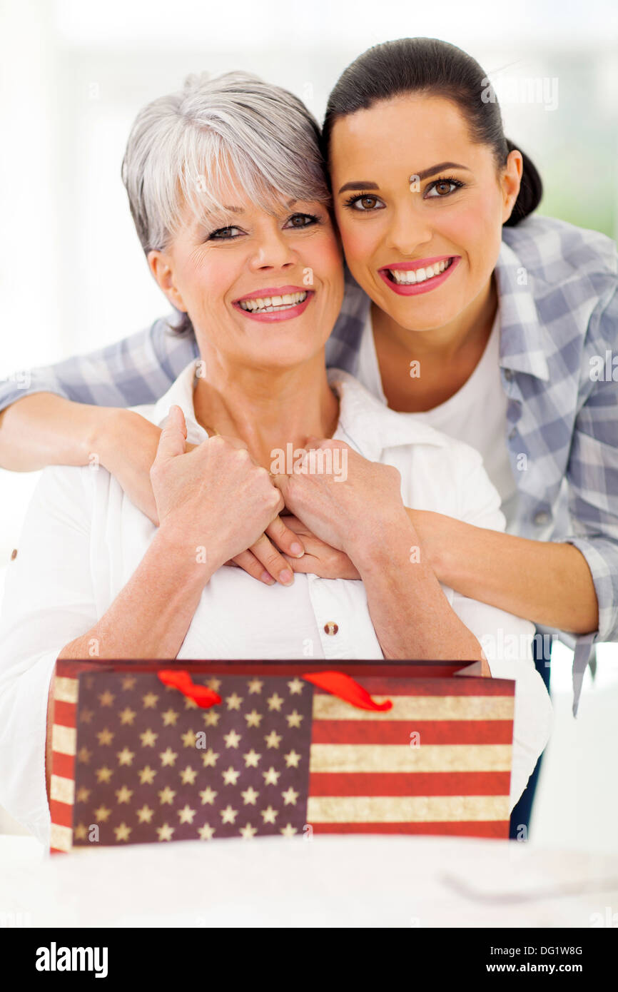 Loving young adult daughter makes an unexpected surprise to her mature  attractive mom, gives her a gift. Friendship of mom and daughter Stock  Photo - Alamy