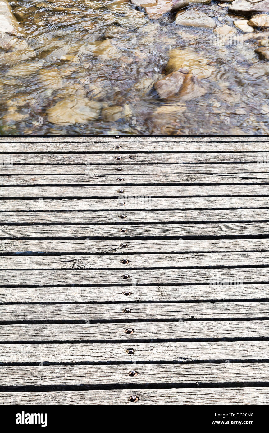 Wooden bridge over mountain river Stock Photo