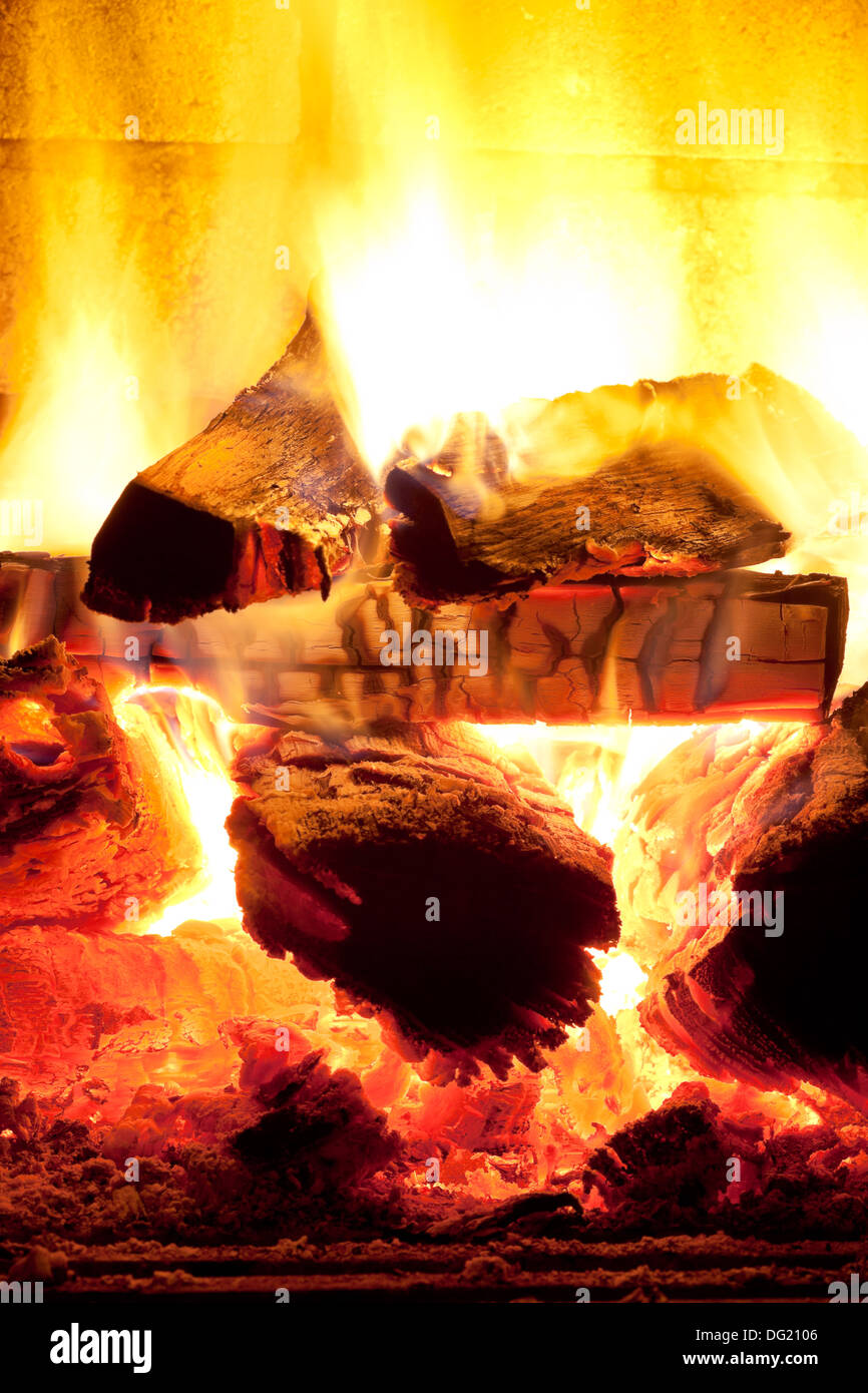 burning wood in fireplace in evening time Stock Photo