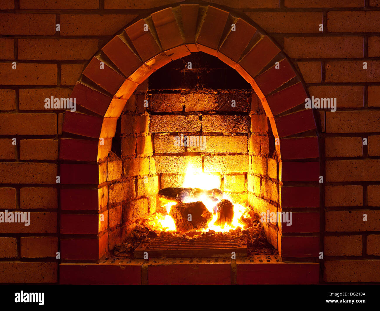 flames of fire in fireplace in evening time Stock Photo