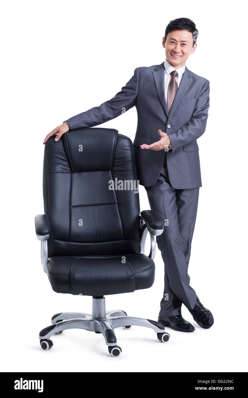 Mature businessman with boss chair Stock Photo