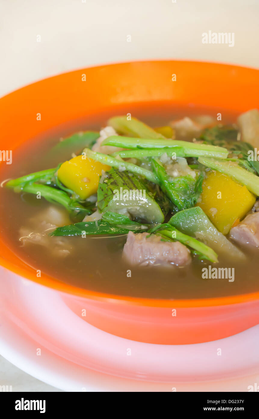 savoury thick soup made from pork , spices and mix vegetable in orange bowl , asian soup Stock Photo