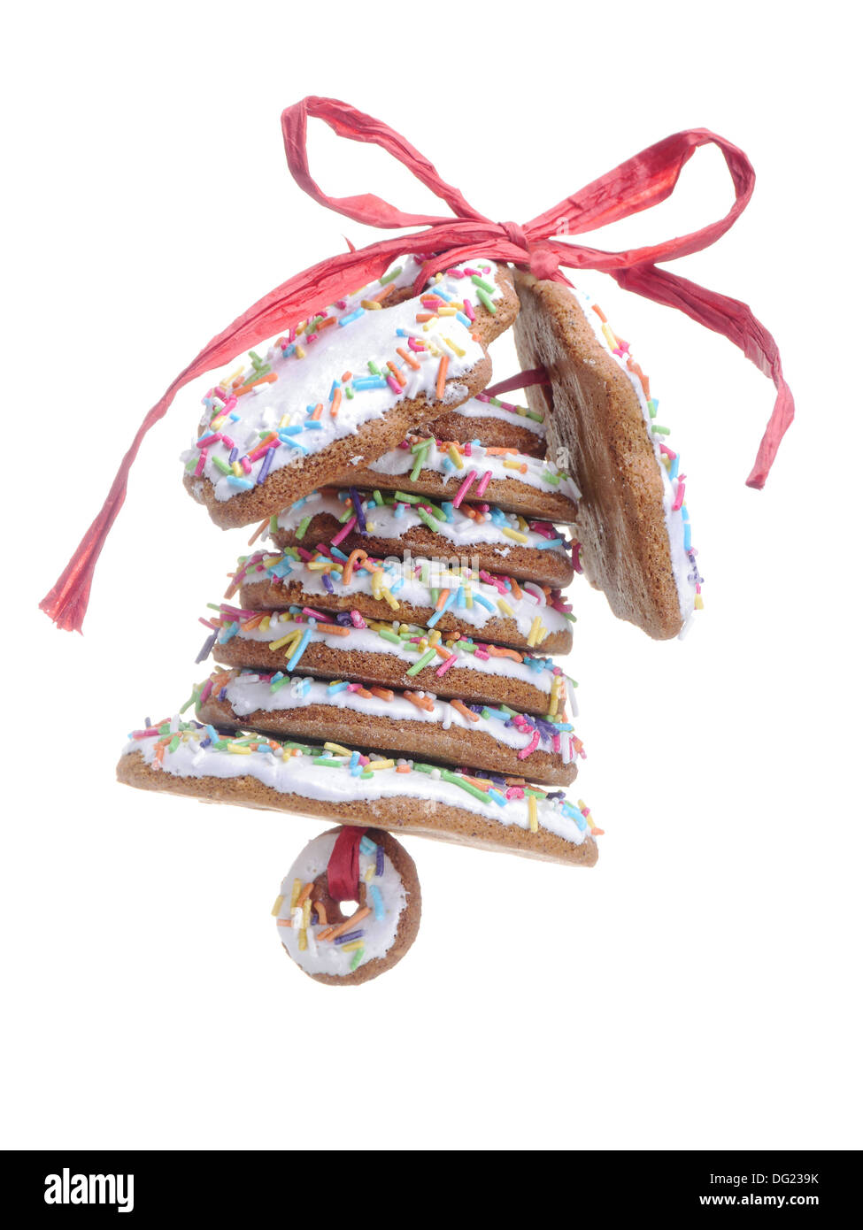 Christmas bell assembled from gingerbread shaped cookies and tied with red ribbon shot over white blue background Stock Photo