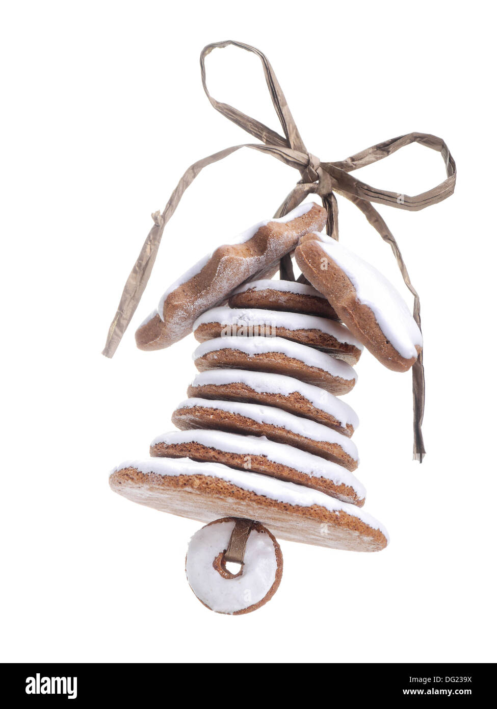 Christmas bell assembled from gingerbread shaped cookies and tied with golden ribbon shot over white blue background Stock Photo