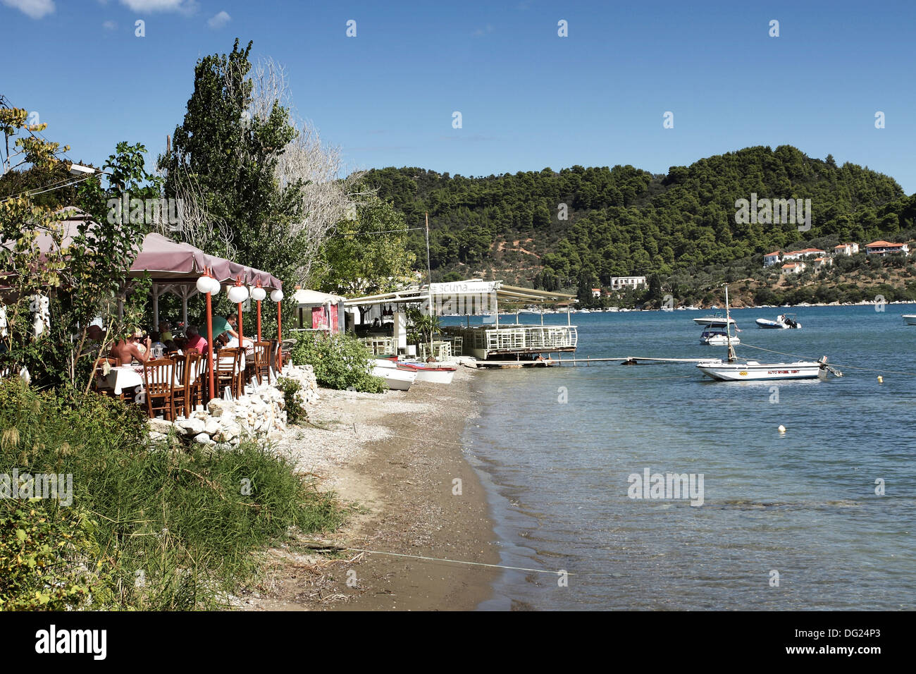 A beach front Taverna in Skiathos Town on the Greek Island of Skiathos, a popular tourist destination in the Aegean Sea. Stock Photo