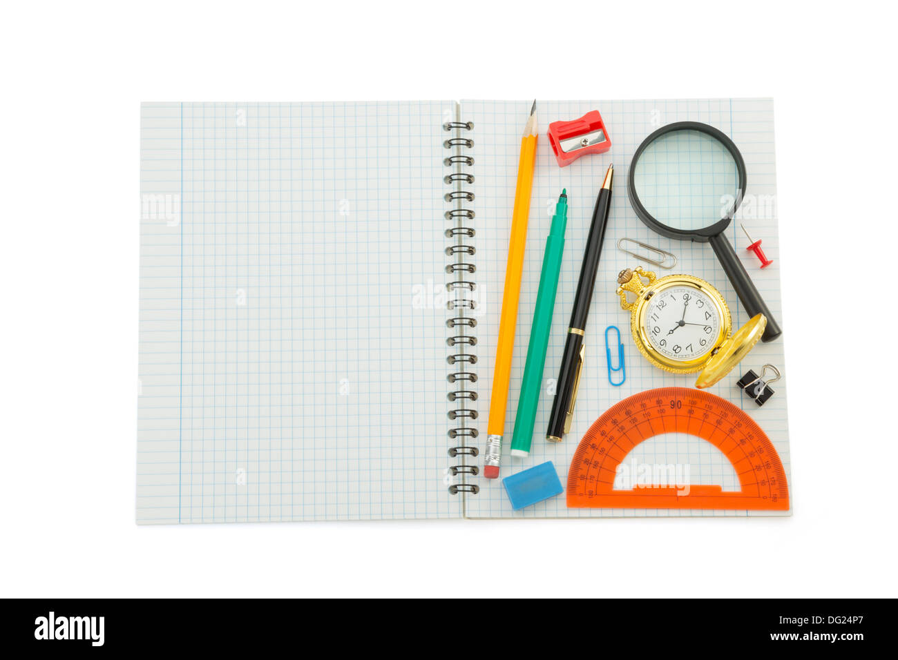 school supplies on checked notebook isolated at white background Stock Photo